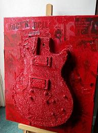 Ivan's Guitar artwork, with the guitar destroyed at Leeds Festival